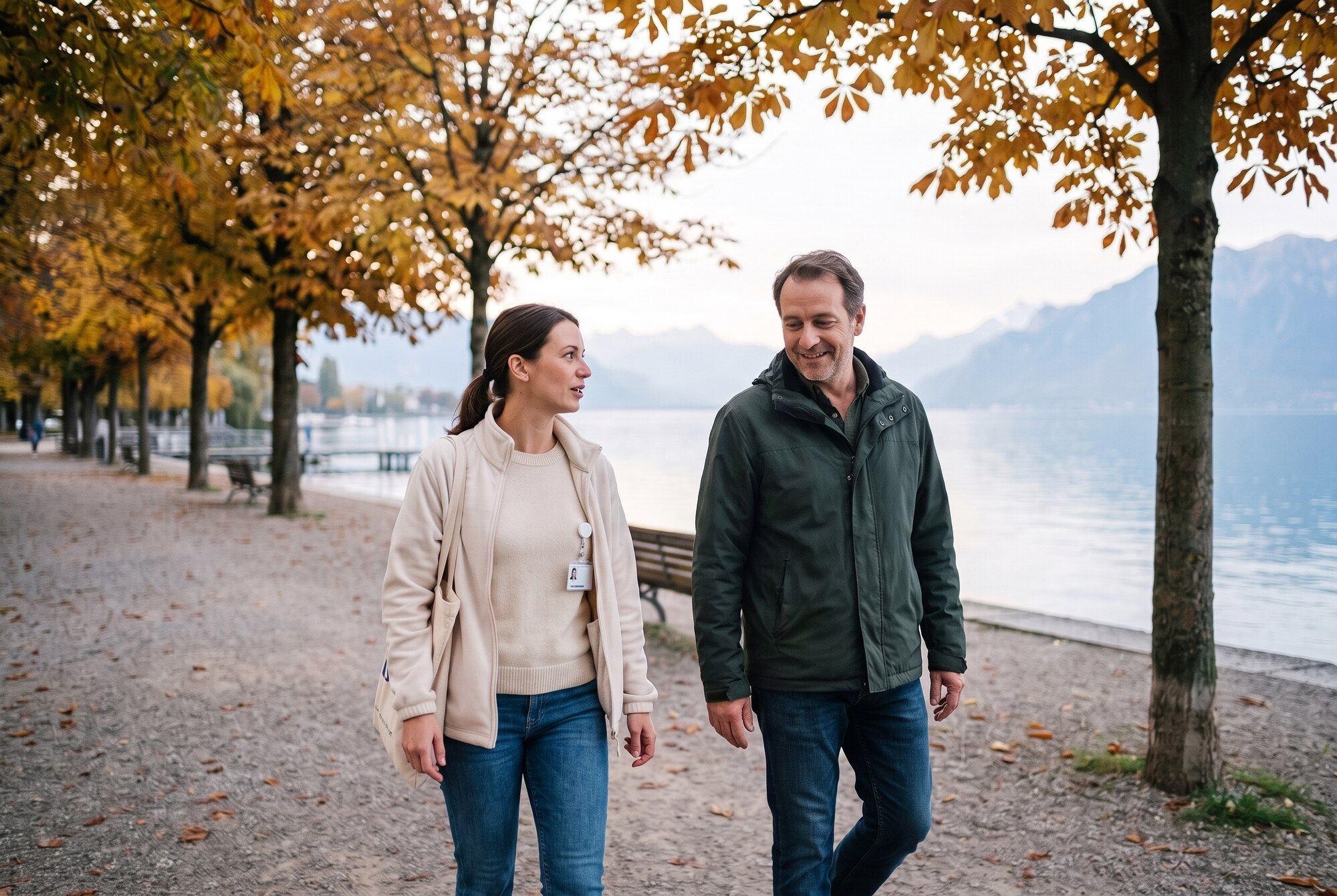 Nurse and patient walking by the lake in autumn